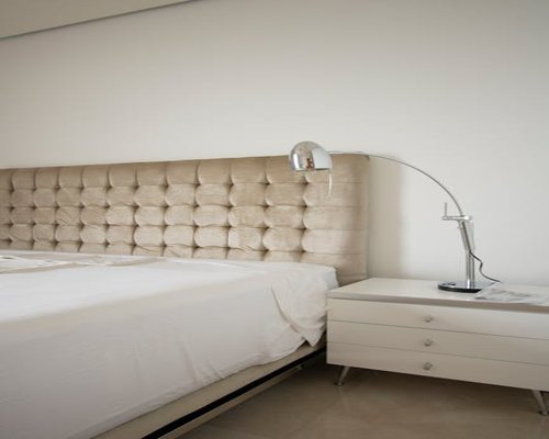 Minimalist bedroom setup showing a clean nightstand with an adjustable reading lamp